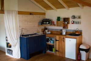 Small kitchen with fridge, electric hob and counter-top oven