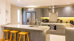 Downstairs kitchen showing ice maker. Both kitchens feature dishwashers.