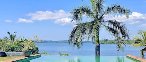 15m x 7m non-slip slate pool with rock face waterfall at the infinity edge.