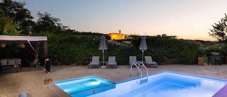 Calm summer nights by the pool with a view to the ancient church.