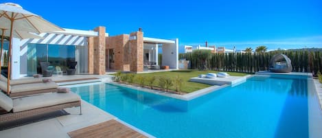 Exterior of the house: private garden and pool with hammocks and chill out