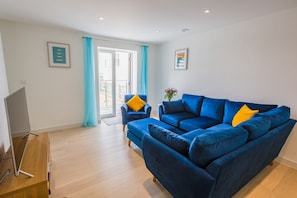Lounge with doors leading to balcony