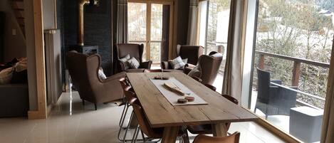 Kitchen table and seating area by fire, with access to balcony and lovely views.