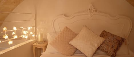 Relax in the extra large king size beds with refurbished antique bedheads