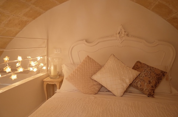 Relax in the extra large king size beds with refurbished antique bedheads