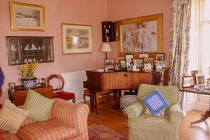 Baby grand piano in drawing room.