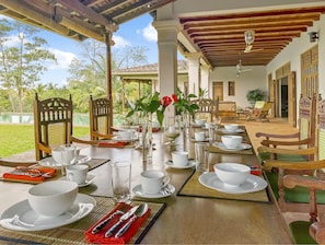 Dining on the veranda. Furniture is all handmade from recycled jakwood.