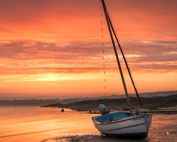 The tidal estuary at sunset.  The slipway to the beach is opposite the cottage