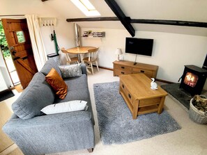 Light and bright cosy living area with character beams.