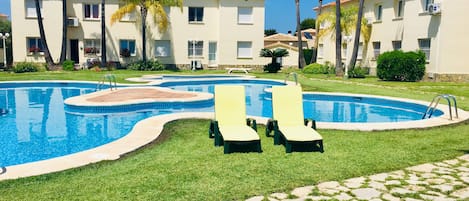relax on our deckchairs by the pool