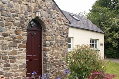 Cottage in Pembrokeshire with large garden, small stream and summer house.