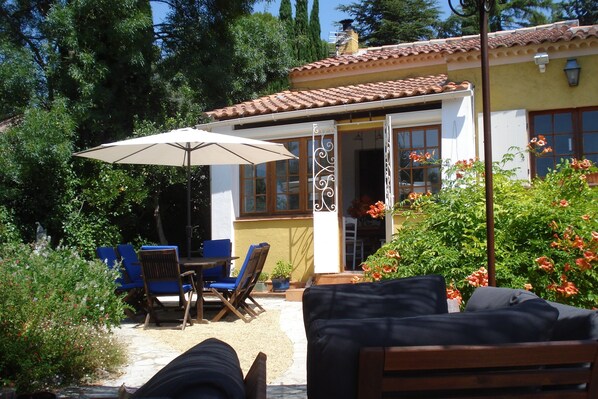 View from main terrace seating area to dining area and house