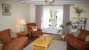 lounge with french windows opening onto private terrace with bbq