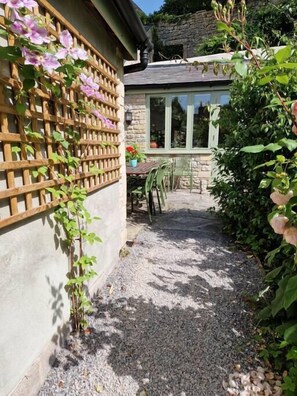 The path leading up to the cottage entrance through the private courtyard.