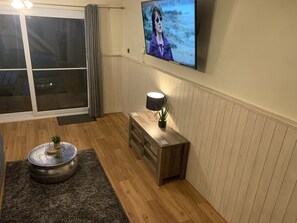 Lounge Area  has wall mounted Large Flat Screen TV 