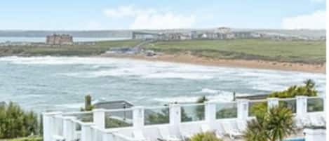 Spacious gardens  and swimming pool  with stunning views over Fistral Beach 