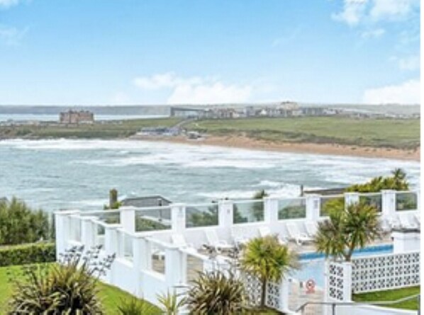 Spacious gardens  and swimming pool  with stunning views over Fistral Beach 