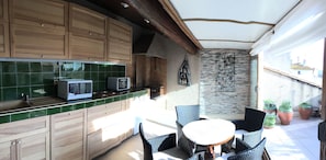 Sunlit veranda kitchen, breakfast area opening to the rooftop terrace