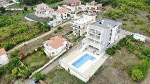 Aerial view of building, Forrest to the rear and beach to the front