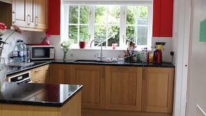 Designer kitchen with induction hob, fitted fridges and bins