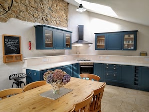 Exposed granite wall adds real character to the large kitchen-diner