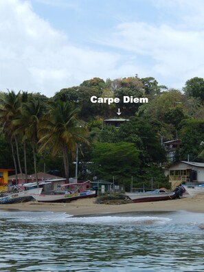 Carpe Diem nestled between the trees overlooking Castara bay