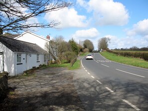 general outside view of cottage with parking area to front