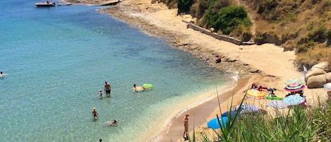 Sandy, cute Spartia beach: shallow, warm waters, few rocks around for snorkeling