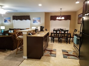 Full-size kitchen, dark cabinets, granite countertops, stainless steel appliance