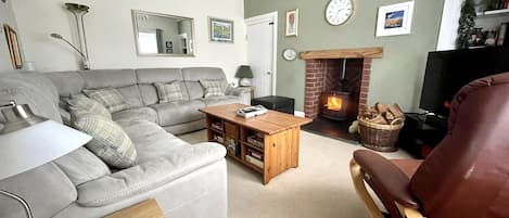 Cosy and comfortable lounge with woodburner, tv, games and books