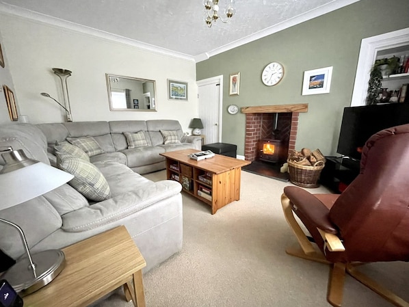 Cosy and comfortable lounge with woodburner, tv, games and books