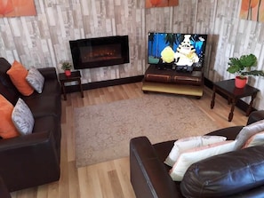 Spacious, comfy lounge area with electric fire and new smart television