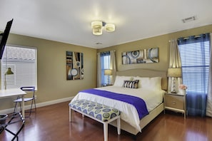 Master bedroom with a king size bed, desk 