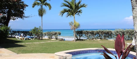 Spectacular beachside villa with pool in lush tropical garden 