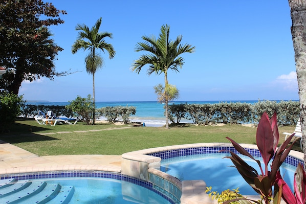 Spectacular beachside villa with pool in lush tropical garden 