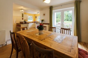 Open plan dining area with french doors leading into the garden.