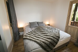 Chambre d’angle avec deux portes fenêtres donnant accès à deux balcons. Vues sur