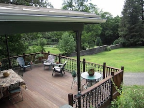 Spacious deck for dining, reading and sunning with a view of the walled garden