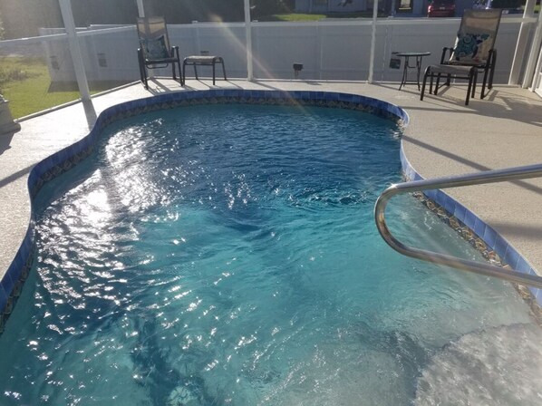 Enjoy the shimmering blue water of this newly added swimming pool off the lanai.