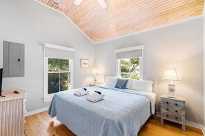One of the two guest bedrooms featuring a king bed and smart tv