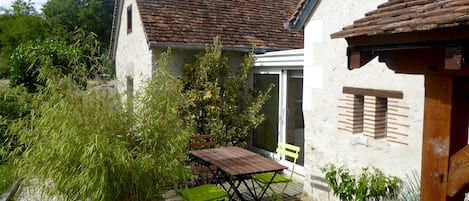 Patio with outside dining table and BBQ. Accessible through the veranda.