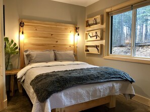 Queen bed in ground floor bedroom.