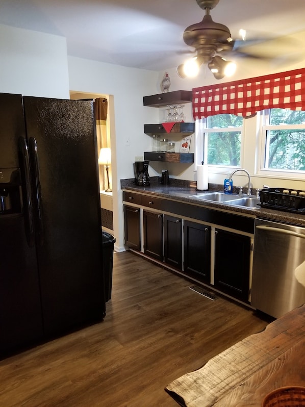 country kitchen, includes dishwasher, gas stove, oven and large refrigerator