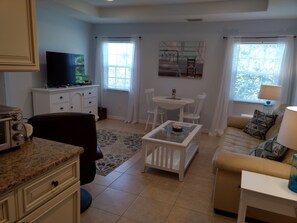 Living room with wide screen TV, Queen sofa bed, dining table open for 4
