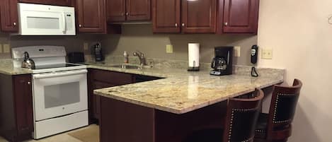 Newly remodeled kitchen with new appliances, granite top counter with bar stools