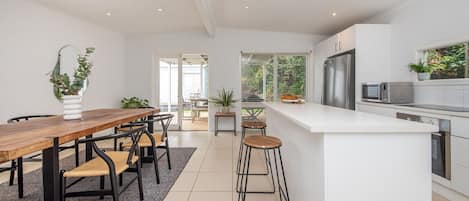 Fully equipped kitchen and dining area with seating for 5