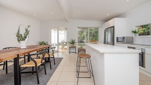 Fully equipped kitchen and dining area with seating for 5