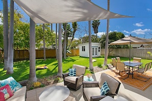 Fully fenced large backyard with tall palm trees rustling in the ocean breeze