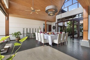 Indoor dining area with square dining table that can seat 12 persons.