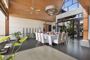 Indoor dining area with square dining table that can seat 12 persons.